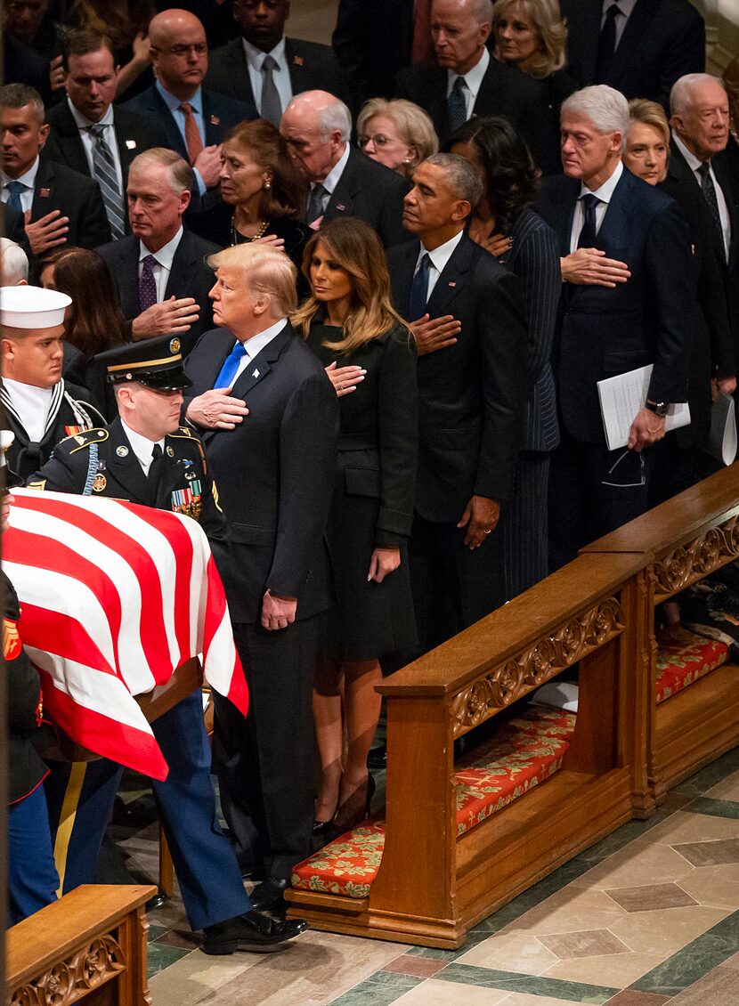 A military honor guard carries the flag-draped casket into the Washington National Cathedral...