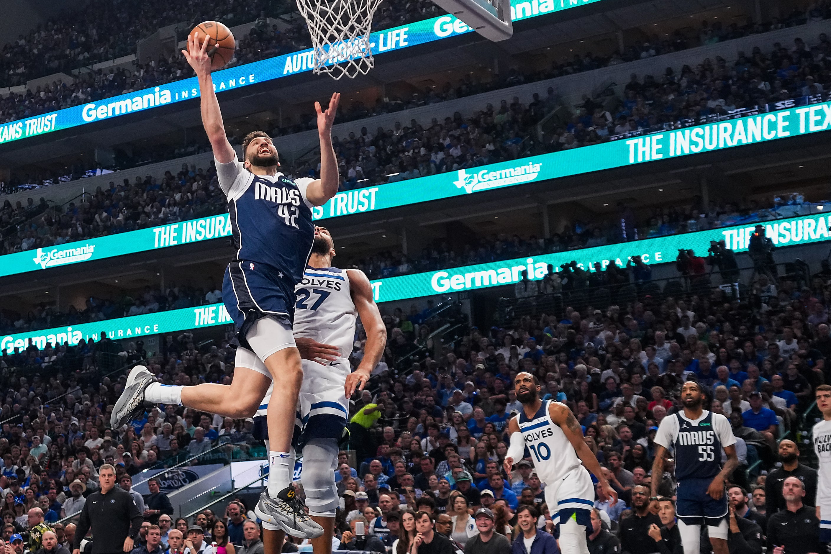 Dallas Mavericks forward Maxi Kleber (42) scores past Minnesota Timberwolves center Rudy...