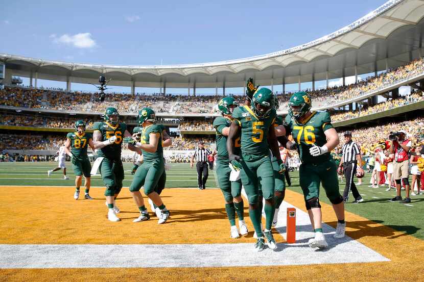 Baylor Bears wide receiver Denzel Mims (5) is congratulated by Baylor Bears quarterback...