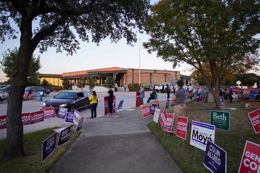 Supporters of various candidates greet voters outside a polling place at Fretz Park Branch...
