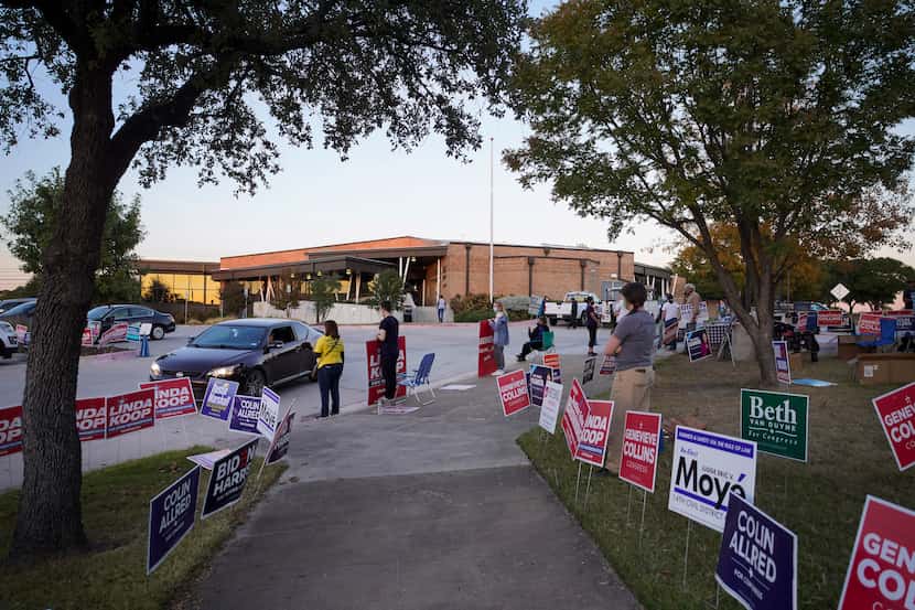 Supporters of various candidates greet voters outside a polling place at Fretz Park Branch...