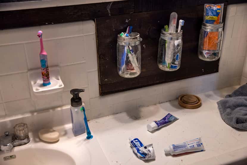 An array of toothbrushes and toothpastes are stored away following a bedtime routine for the...