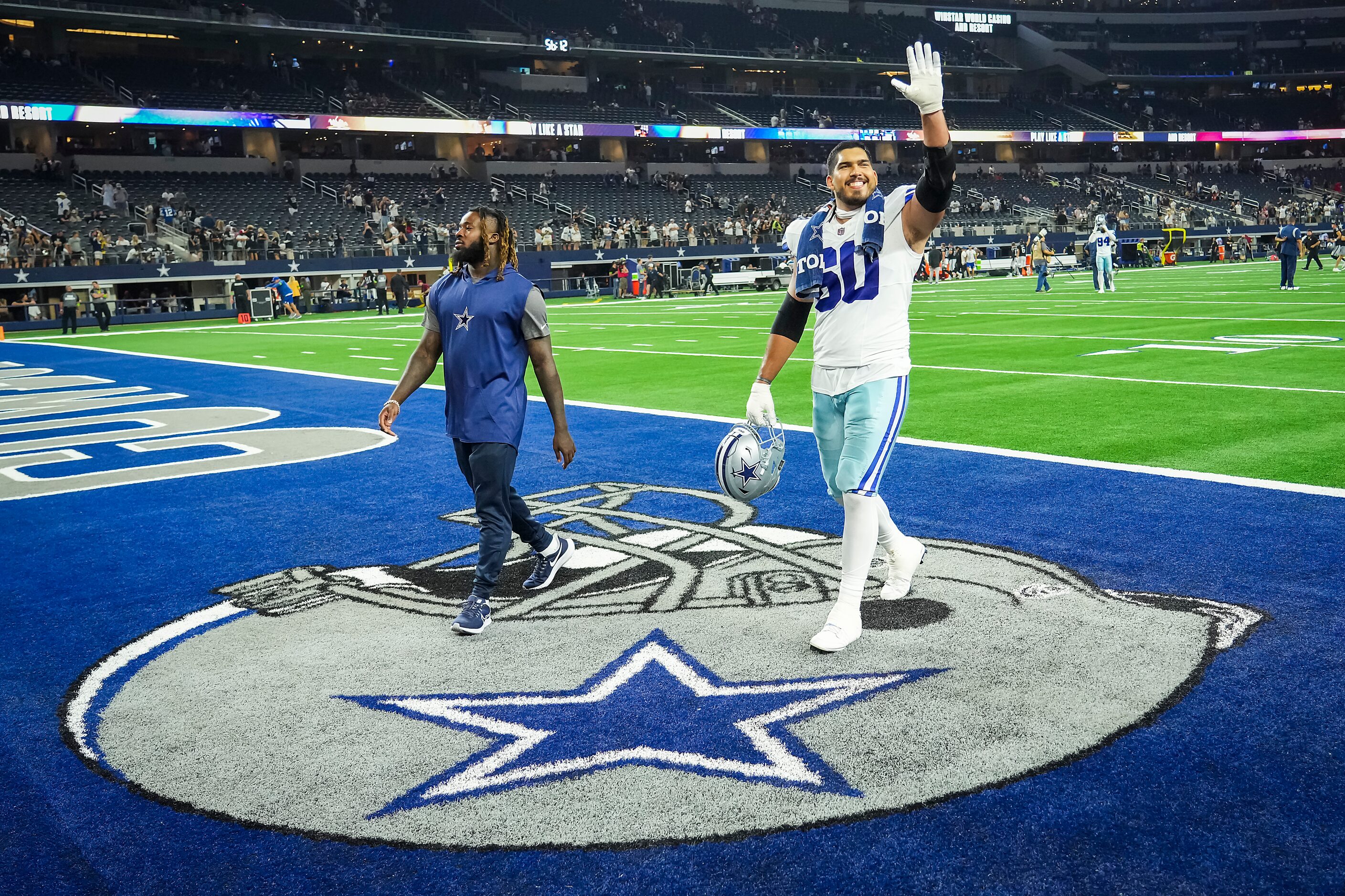 Dallas Cowboys offensive lineman Isaac Alarcon waves as he leaves the field after the...