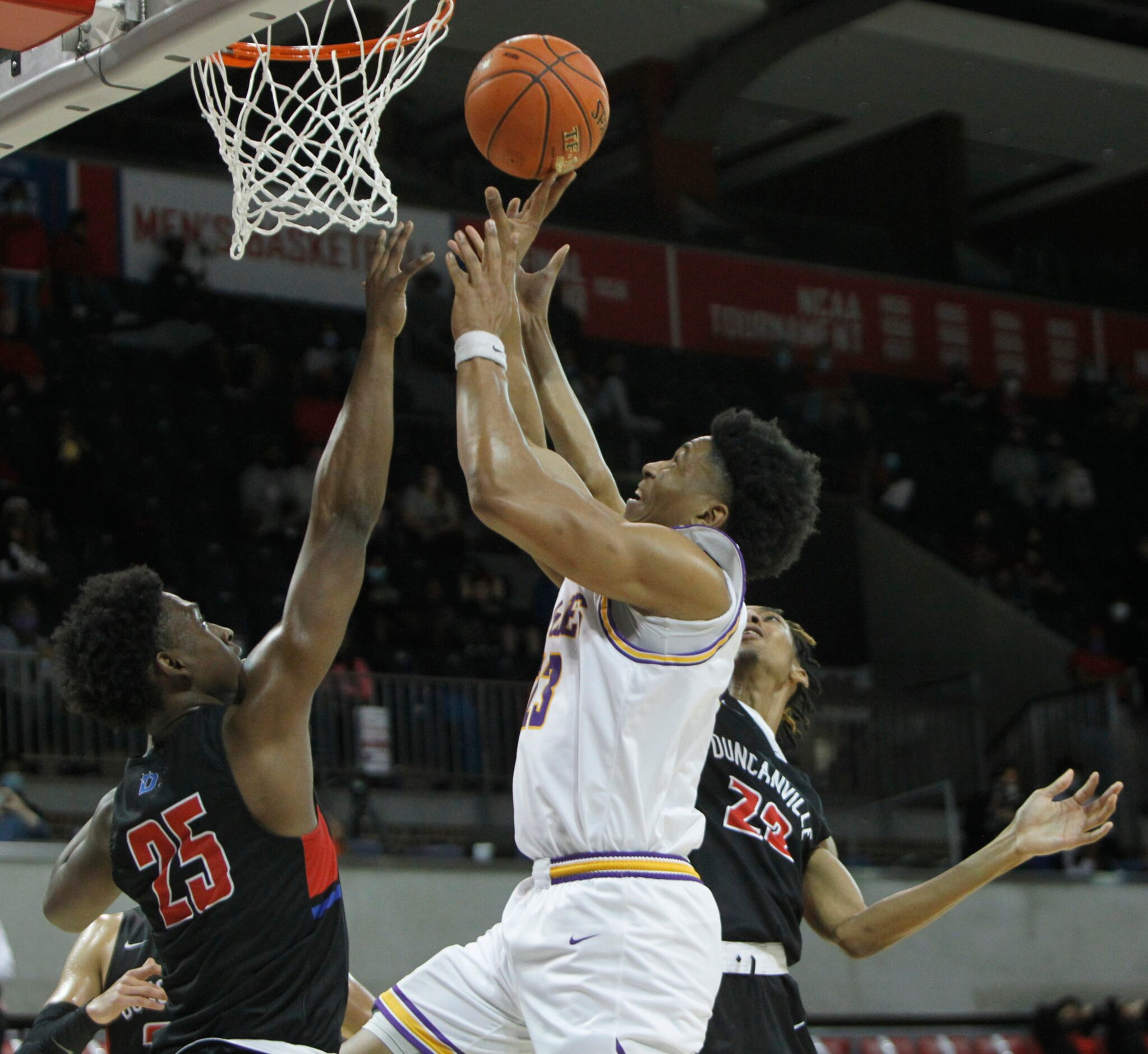 Richardson forward Derek Burns (23) drives to the basket and draws a foul as he is defended...