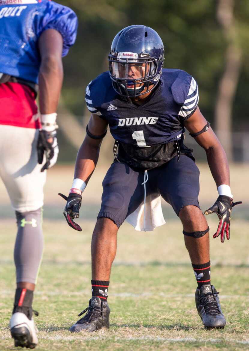 Bishop Dunne's Chevin Calloway (1) covers a Parish Episcopal receiver during a scrimmage at...