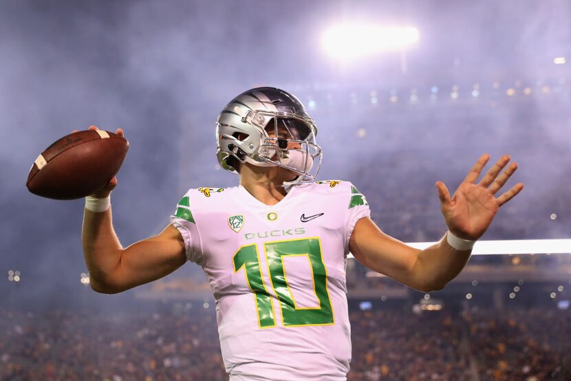 TEMPE, AZ - SEPTEMBER 23:  Quarterback Justin Herbert #10 of the Oregon Ducks warms up...