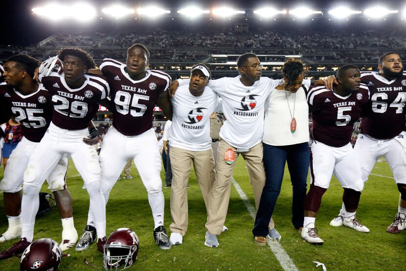 Texas A&M Aggies head coach Kevin Sumlin (center joins his players in the Aggie Warm Hymn...