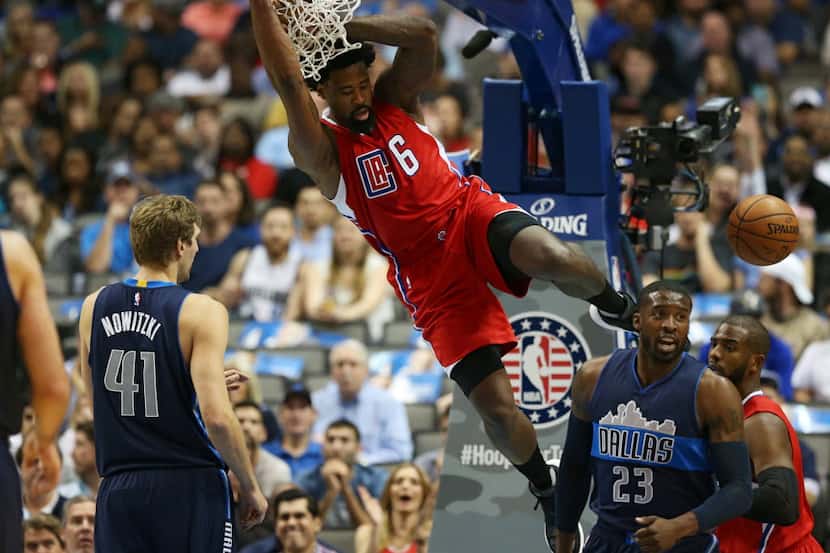 Los Angeles Clippers center DeAndre Jordan (6) hangs on the rim after dunking in front of...