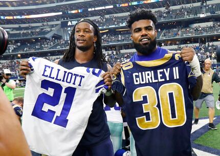 Ezekiel Elliott and Todd Gurley exchange jerseys after a game at AT&T Stadium in Arlington,...