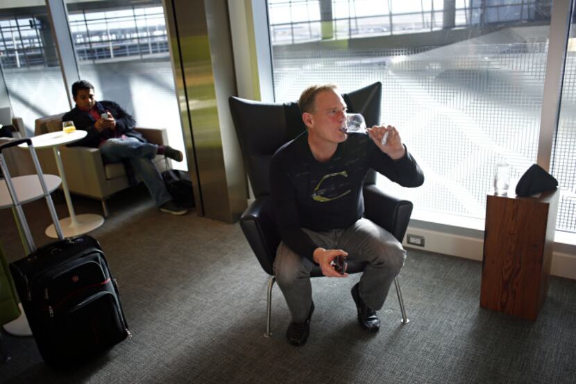 Frequent flier David Wilson sips wine at the new Centurion Lounge in Terminal D at D/FW...