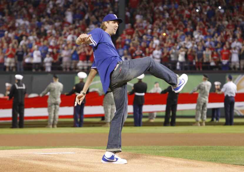 Dallas Mavericks' Dirk Nowitzki throws out the first pitch prior to the start of Game 3 of...