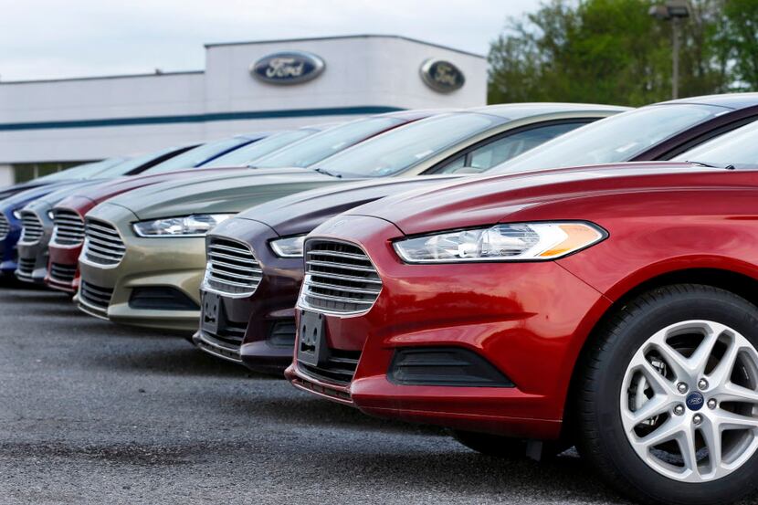 FILE - In this Wednesday, May 8, 2013 file photo, a row of new 2013 Ford Fusions are on...