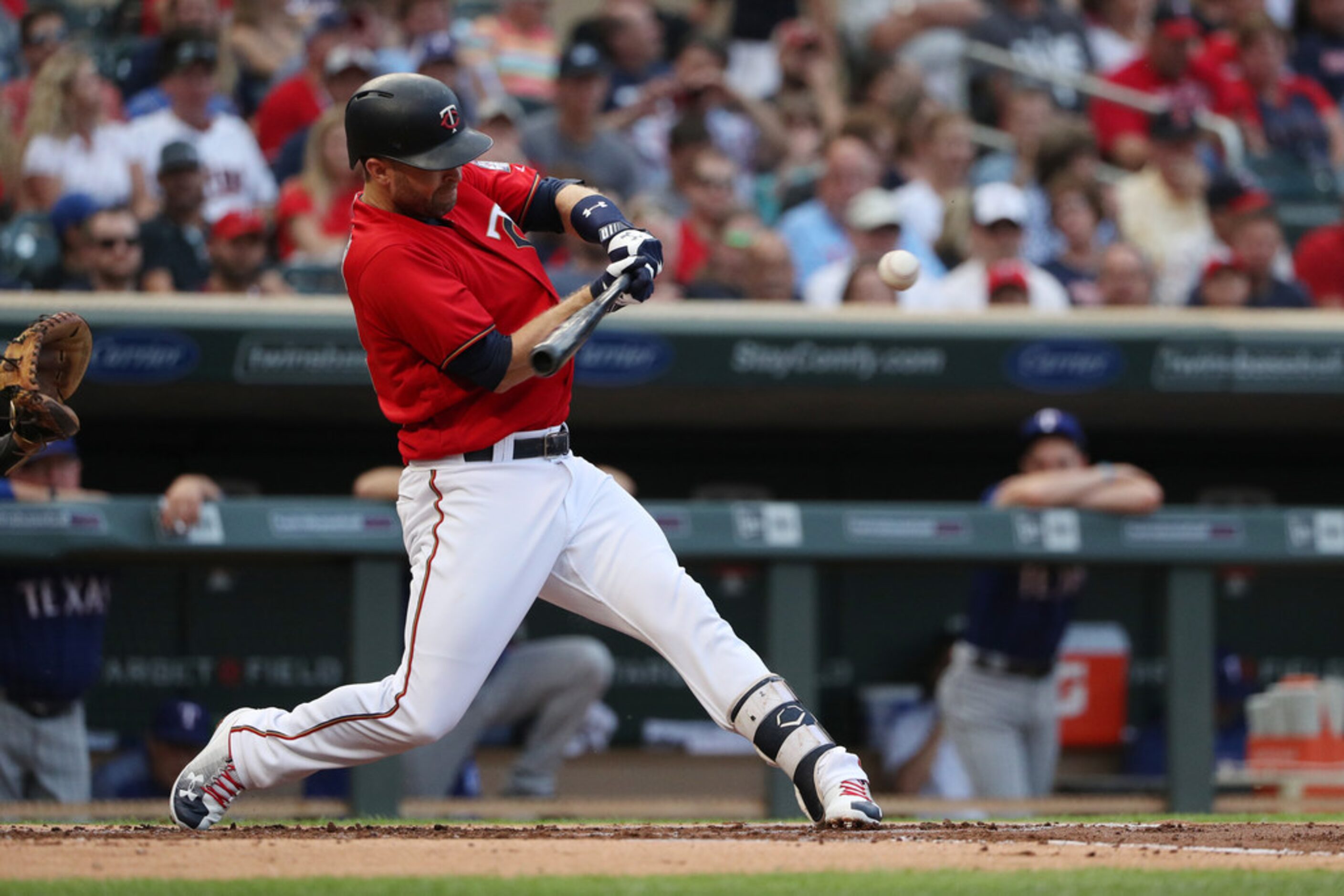 The Minnesota Twins' Brian Dozier singles in the first inning against the Texas Rangers on...