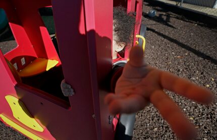  A child plays at a playground of Hope's Door in Plano that offers a shelter and counseling...