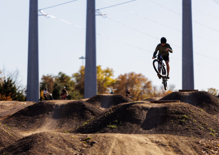 Hart Haskin from Lewisville, TX, jumps his mountain bike at a trail adjacent to the The...