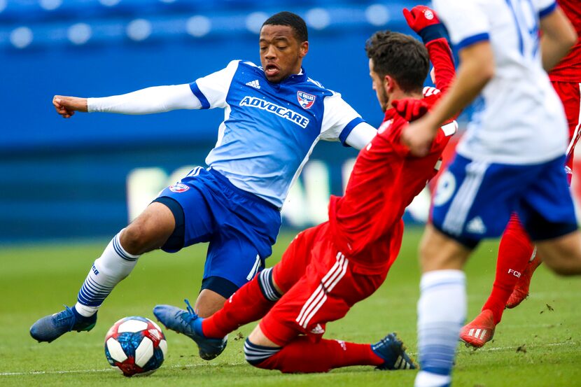 FC Dallas midfielder Jacori Hayes (15) slide tackles Bayern Munich midfielder Daniel Jelisic...