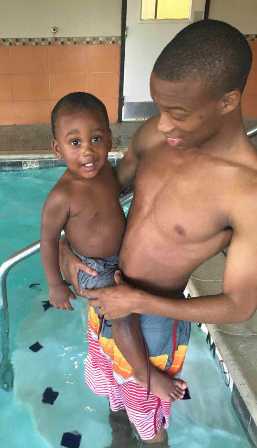 Jaylon Miller held his nephew Rory Norman at a local hotel in southern Dallas, where the two...