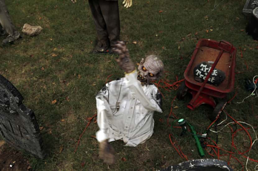 Triggered by a passerby, a motion-sensitive animated Halloween display moves at the home of...