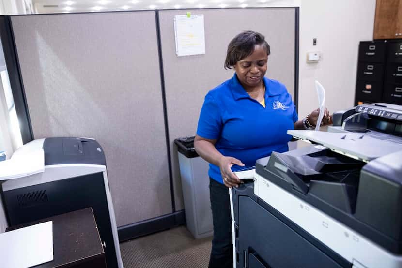 Shipper Monica Sowell makes copies on Aug. 12 at the Black, Mann & Graham office in Flower...