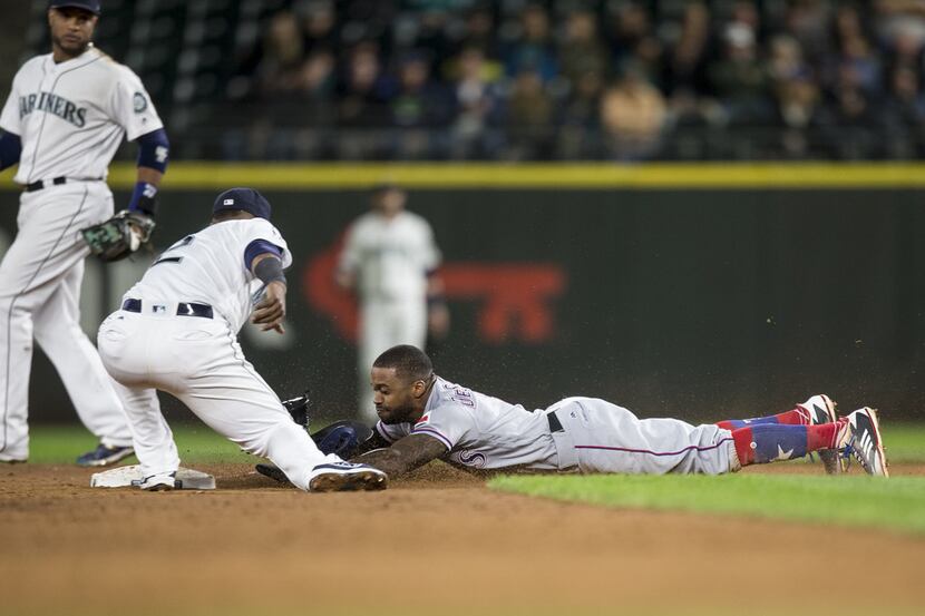 SEATTLE, WA - SEPTEMBER 19: Delino DeShields #3 of the Texas Rangers steals second base,...