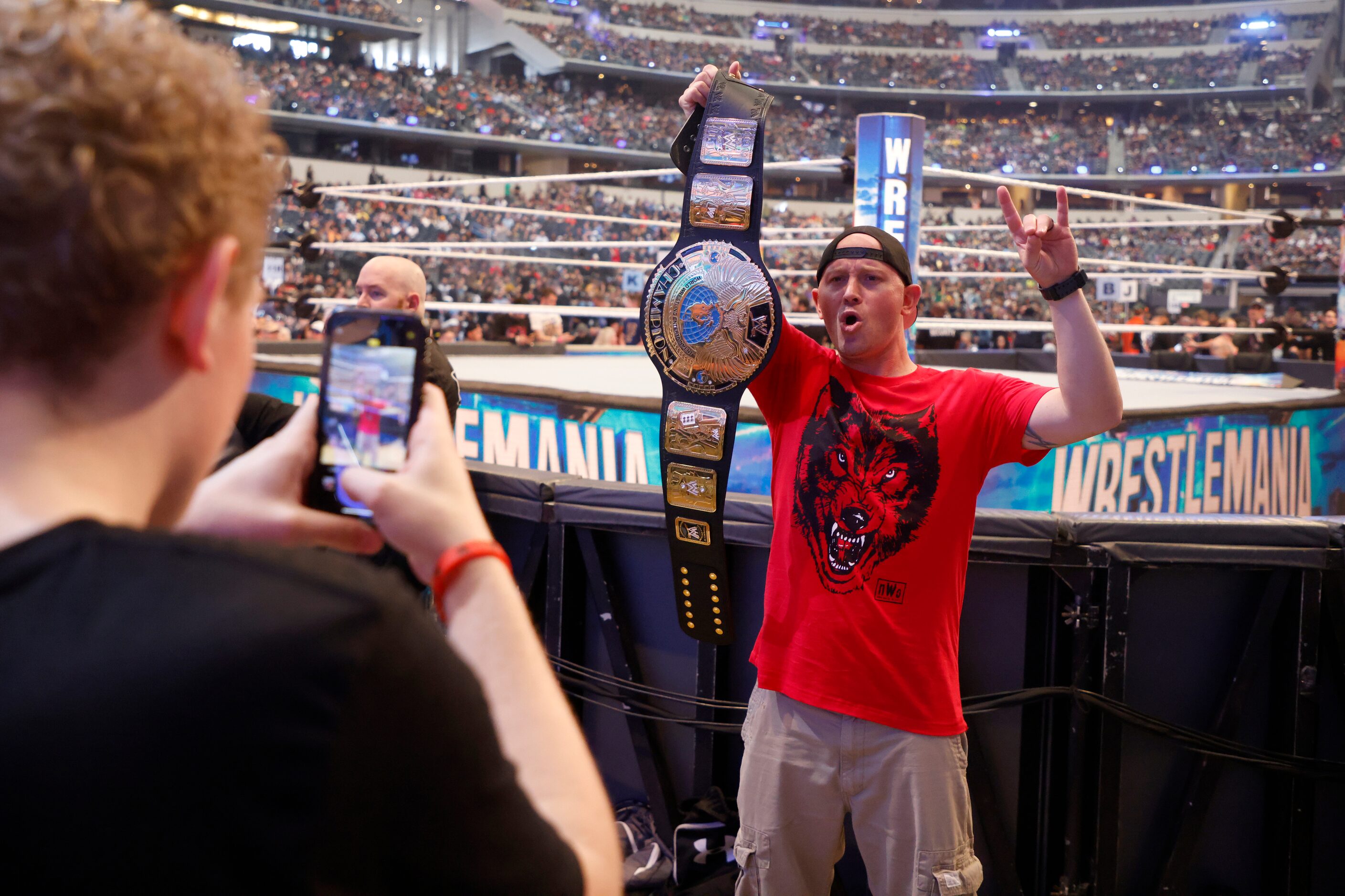 Rylan McNeil, left, of Denver, takes a photo of his father, Mike McNeil prior to...