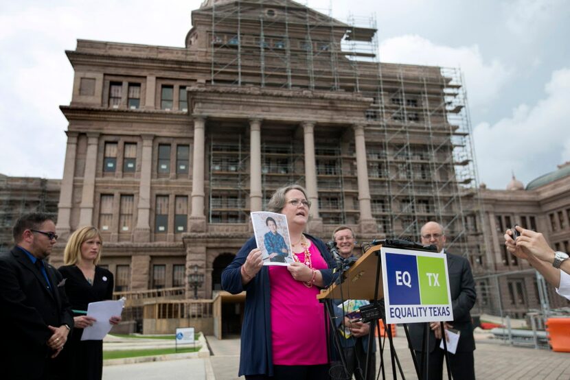 Ann Elder of Friendswood shows a photograph of her child, who was born a girl and who now...