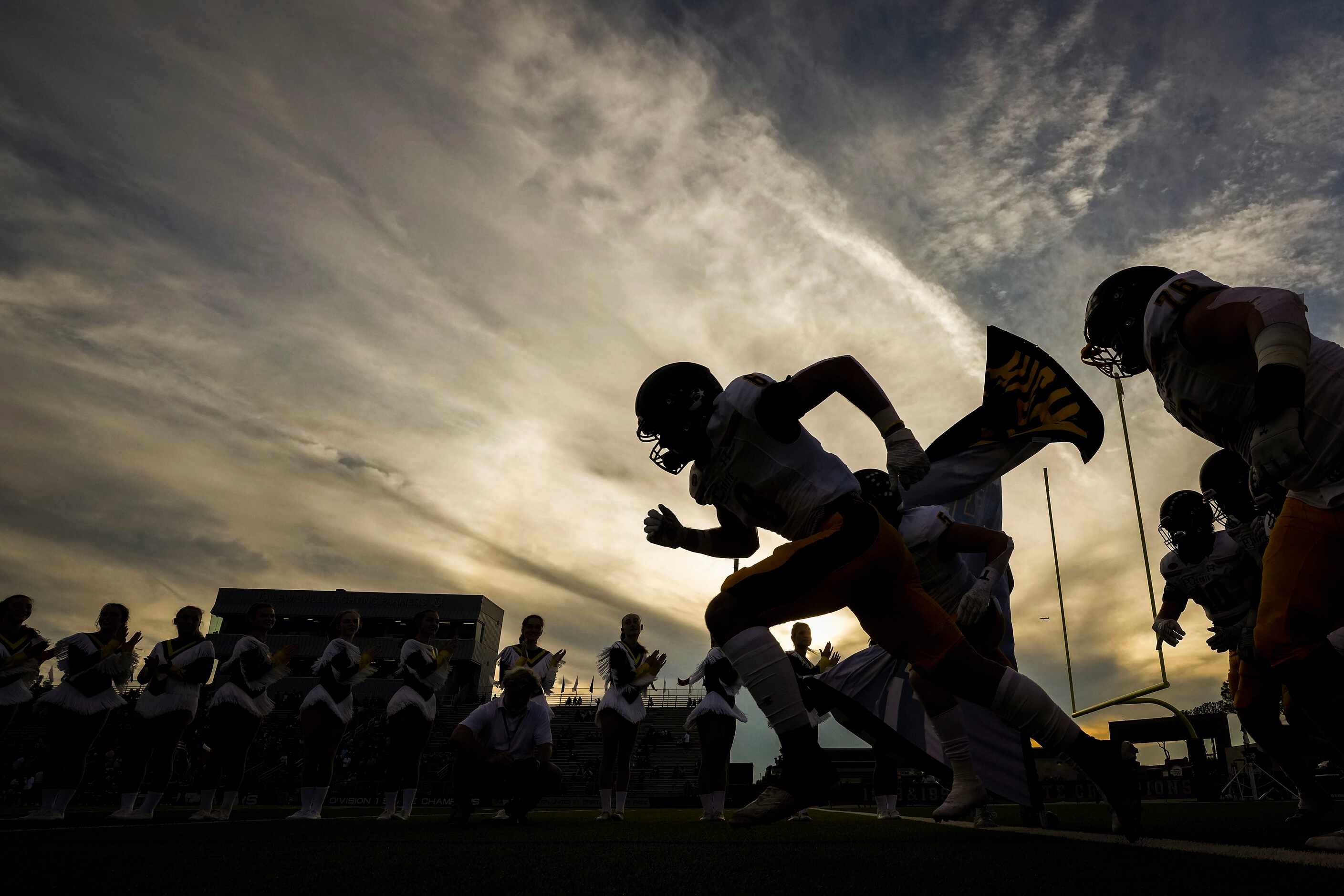 Highland Park players take the field before a high school football game against Lewisville...