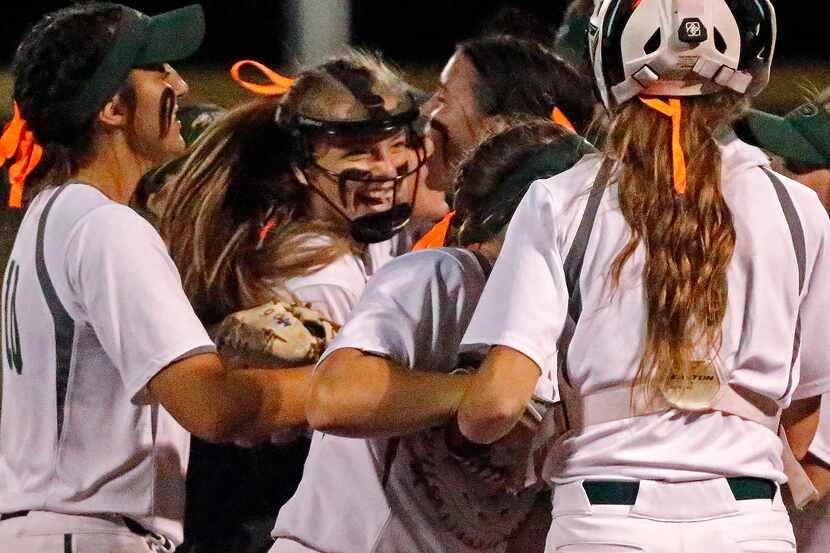Prosper pitcher Elissa Griffin (16) is mobbed by team mates after winning their series as...