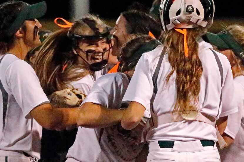 Prosper pitcher Elissa Griffin (16) is mobbed by teammates after winning their series as...