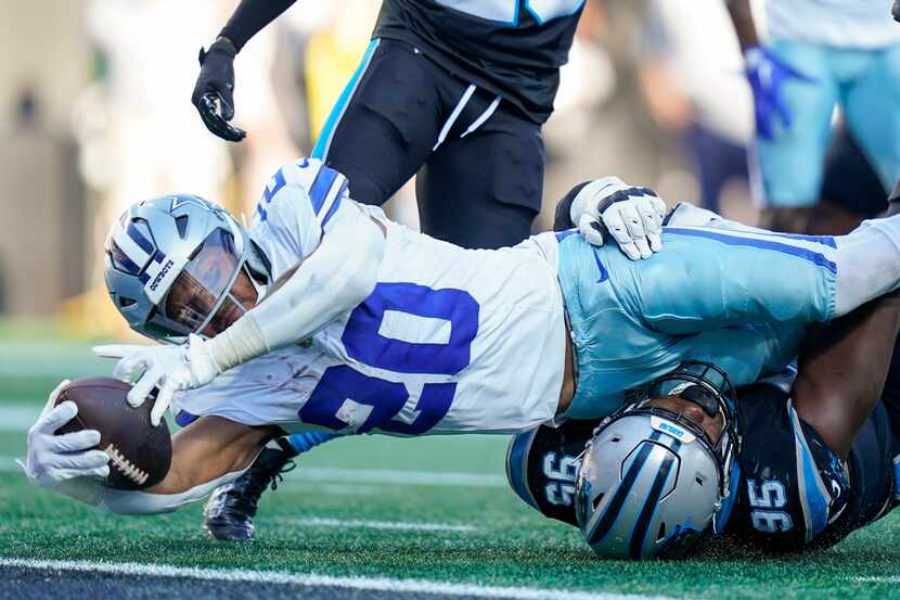 Dallas Cowboys running back Tony Pollard scores past Carolina Panthers defensive tackle...