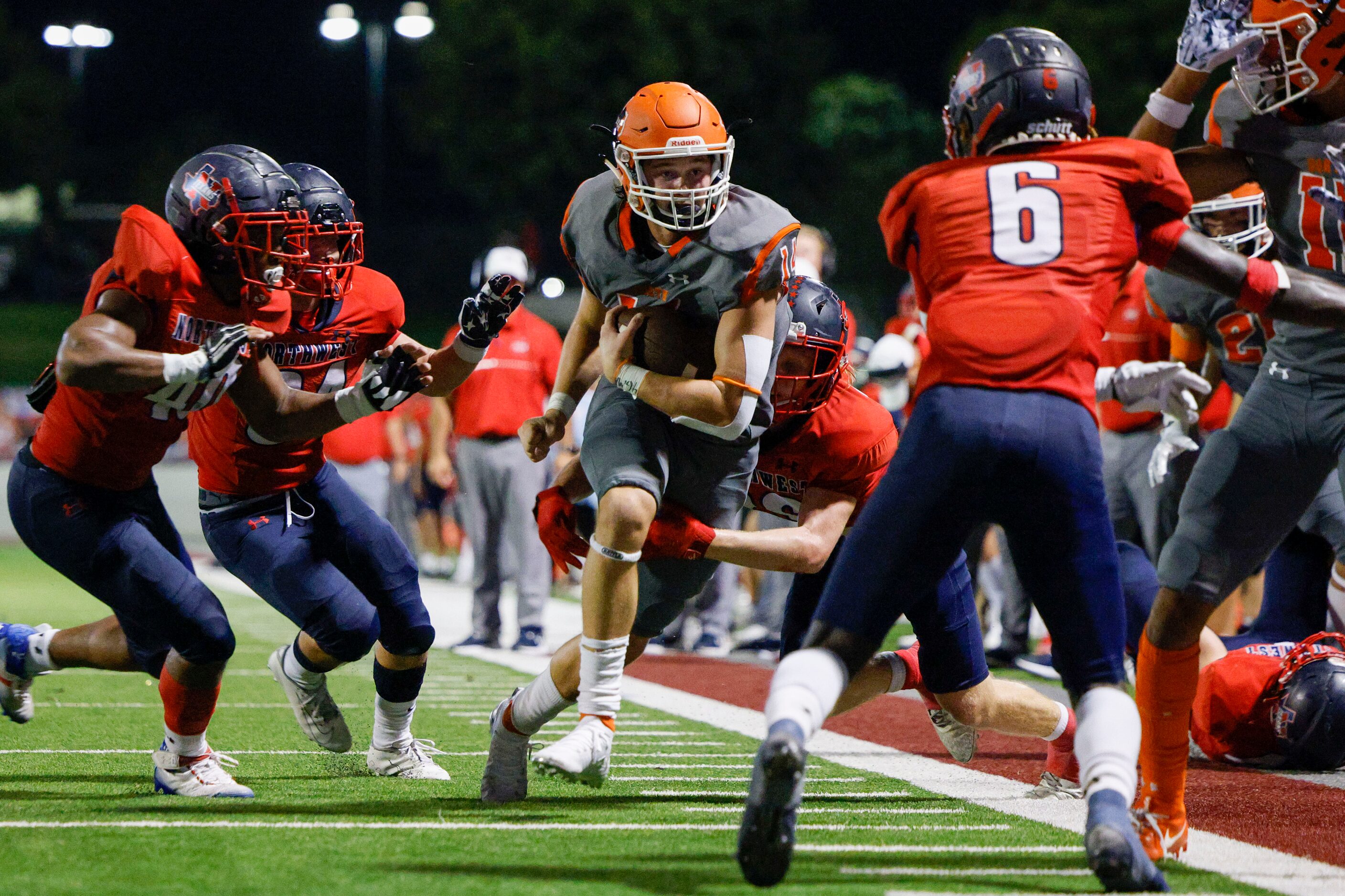 Justin Northwest defensive back Parker Dunmeade (26)  tackles McKinney North quarterback...