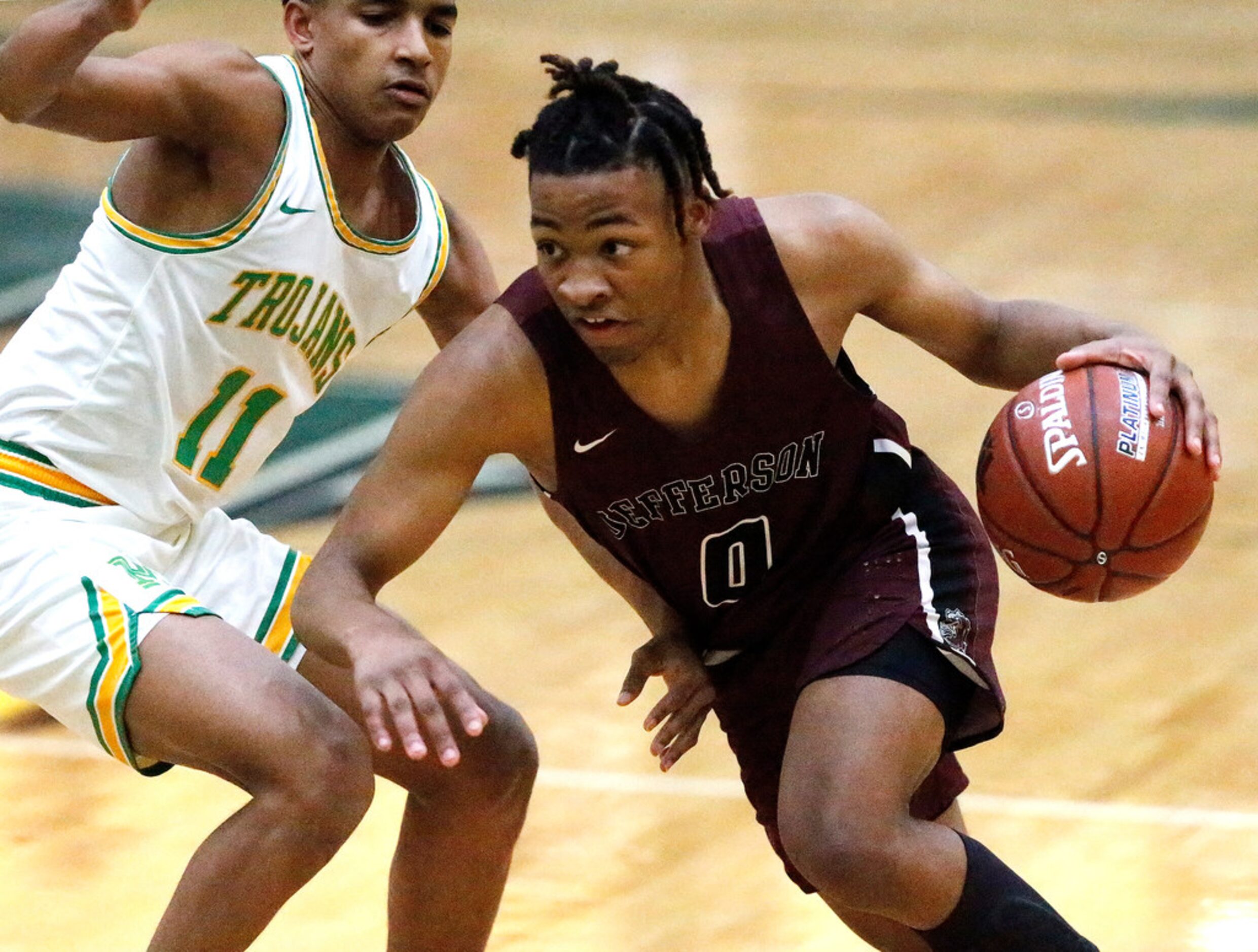 Jefferson High School guard Jakardan Davidson (0) drives as Madison High School Jerome...