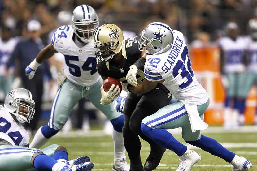 Dallas Cowboys cornerback Orlando Scandrick (32) tries to stop New Orleans Saints running...