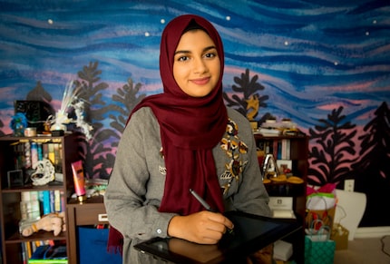 Aaliya Jaleel at home in Richardson, in front of the mural she painted on her wall.