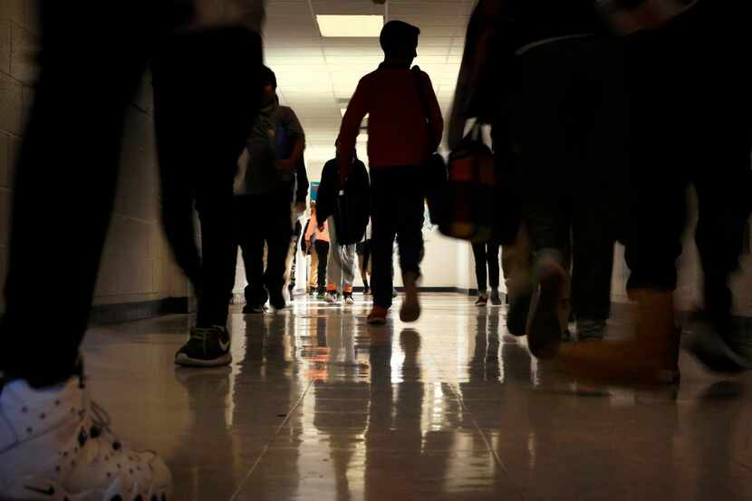 
Students pass through the hallways between periods at J.L. Long Middle School, one of the...