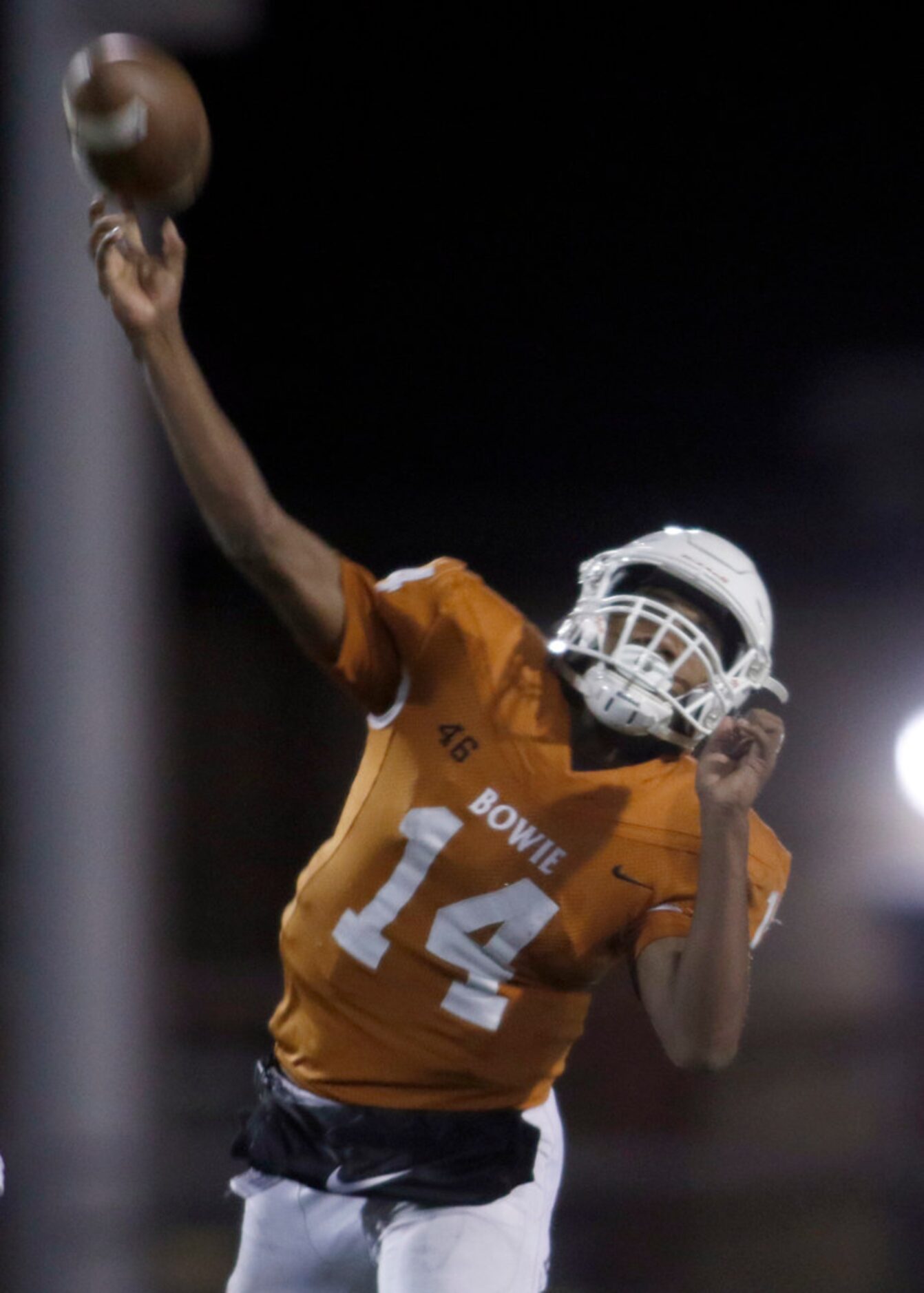 Arlington Bowie quarterback Drevvon Ponder (14) launches a long pass downfield during the...