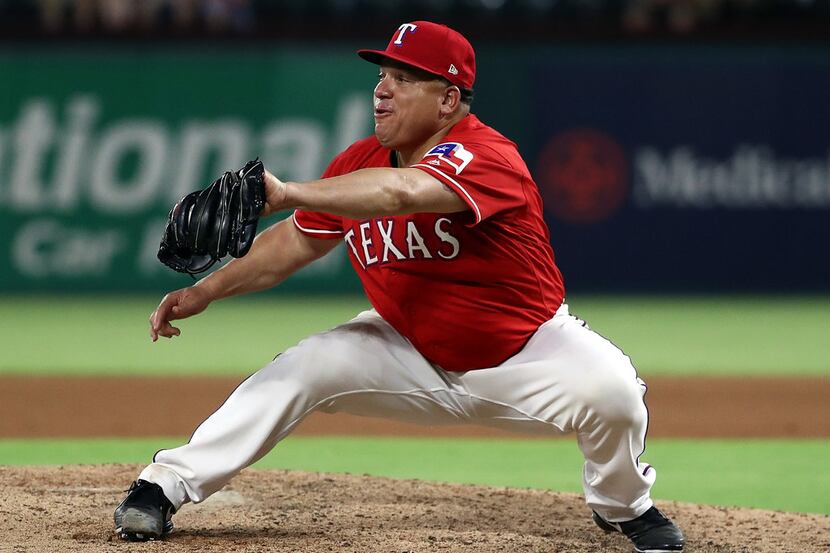 ARLINGTON, TX - AUGUST 07:  Bartolo Colon #40 of the Texas Rangers makes the catch for the...