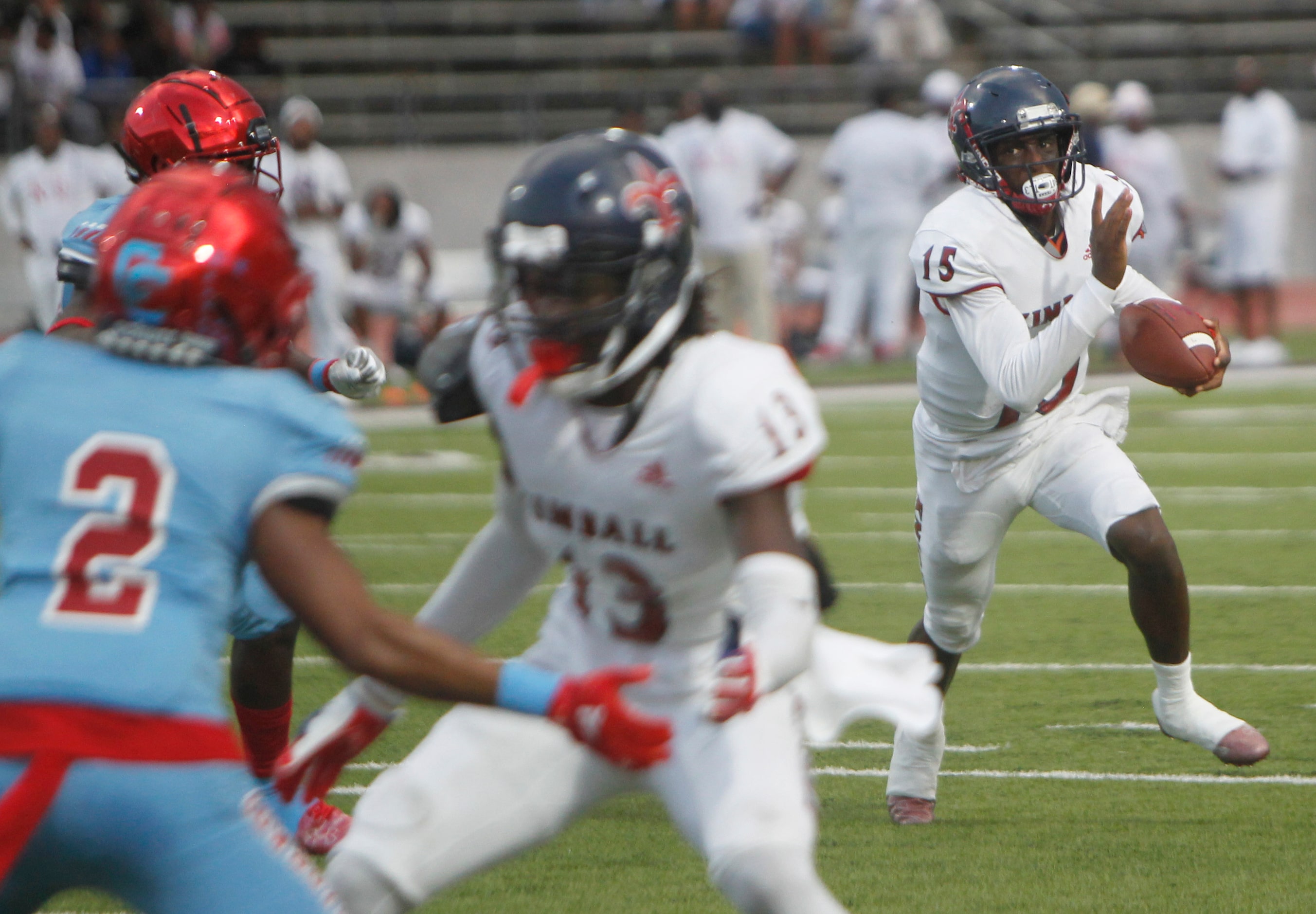 Dallas Kimball quarterback Marc Anderson (15) scrambles out of the backfield on a keeper...