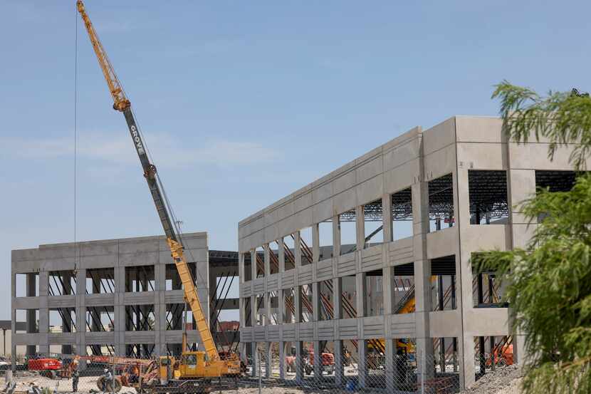 Construction work takes place on 121 Commerce Center in Plano on Wednesday, Aug. 2, 2023....