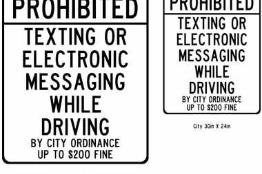  Road signs in Denton alert drivers to city's ban on texting and driving.