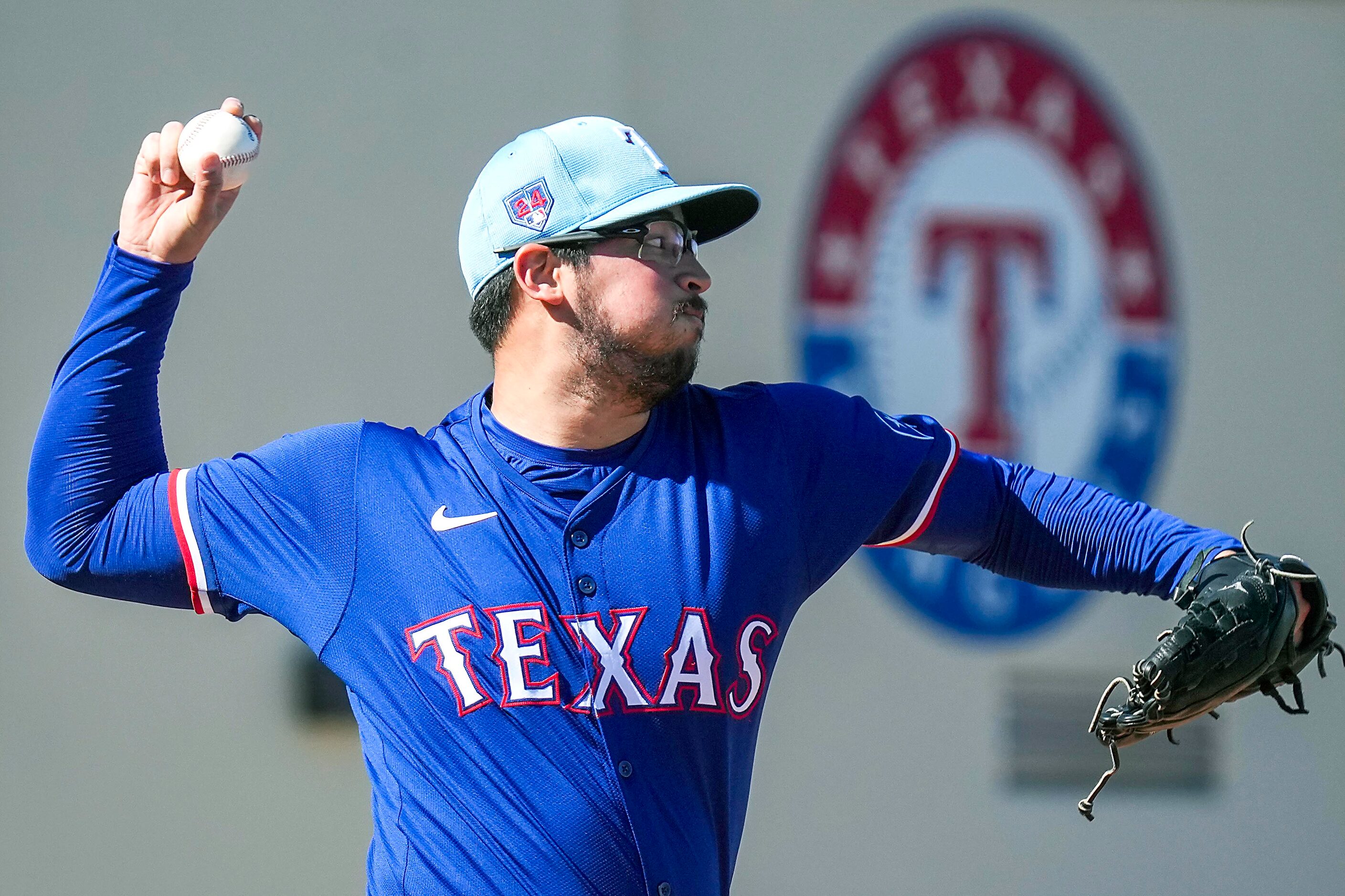 Texas Rangers pitcher Dane Dunning throws in the bullpen during the first Spring Training...