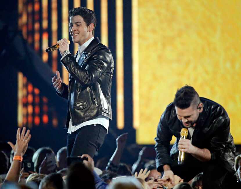 Nick Jonas (left) and Shay Mooney of Dan + Shay perform during the 2015 Academy of Country...