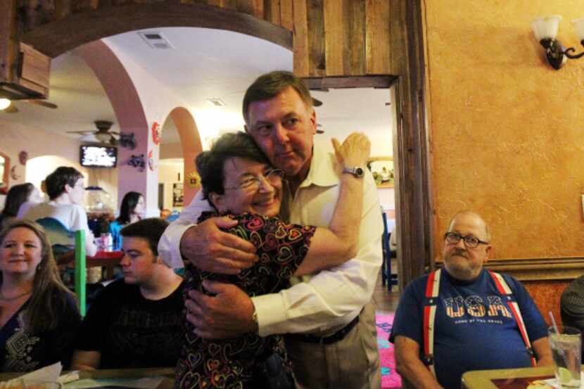 Rick Callahan receives a congratulatory hug from supporter Shirley Stark Saturday after...