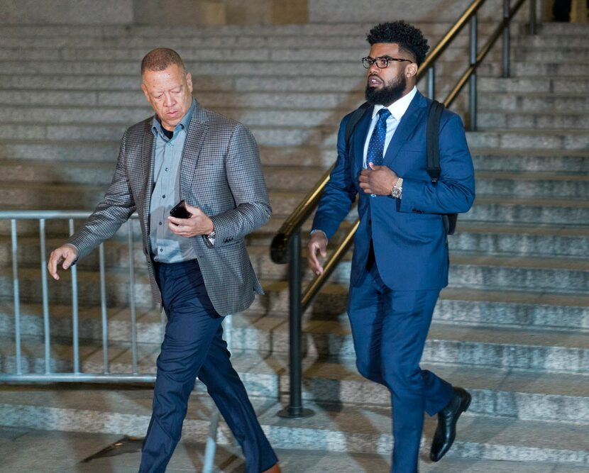 Dallas Cowboys star Ezekiel Elliott, right, exits federal court after a hearing Monday, Oct....