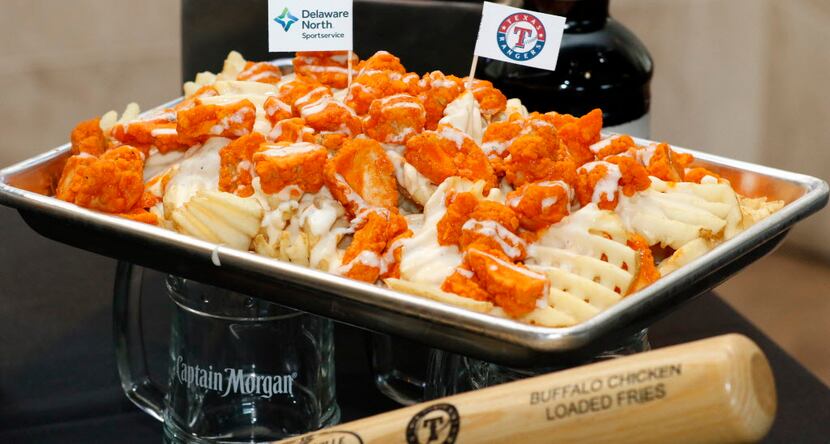 The Buffalo Chicken Loaded Fries are waffle fries topped with buffalo chicken and white...