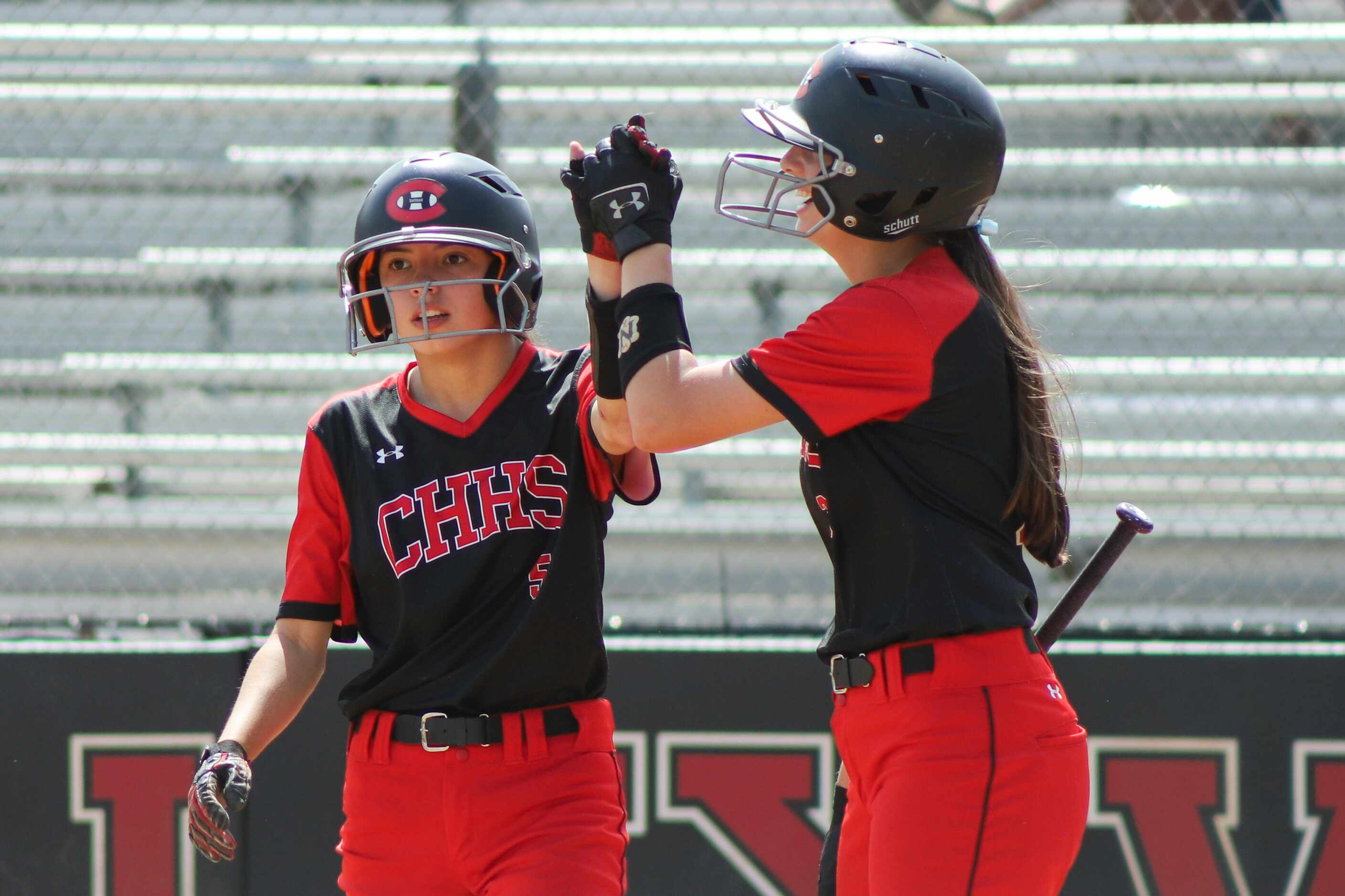 Colleyville Heritage second baseman Leah Perales (5) high fives catcher Alexis Perales (3)...