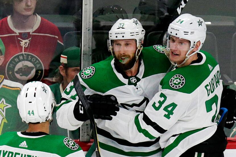 Dallas Stars center Justin Dowling (37) celebrates with teammates Denis Gurianov (34) and...
