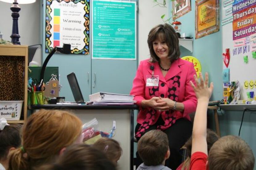 
First-grade teacher Pam Taylor prepares a group of students to make the trek to computer...