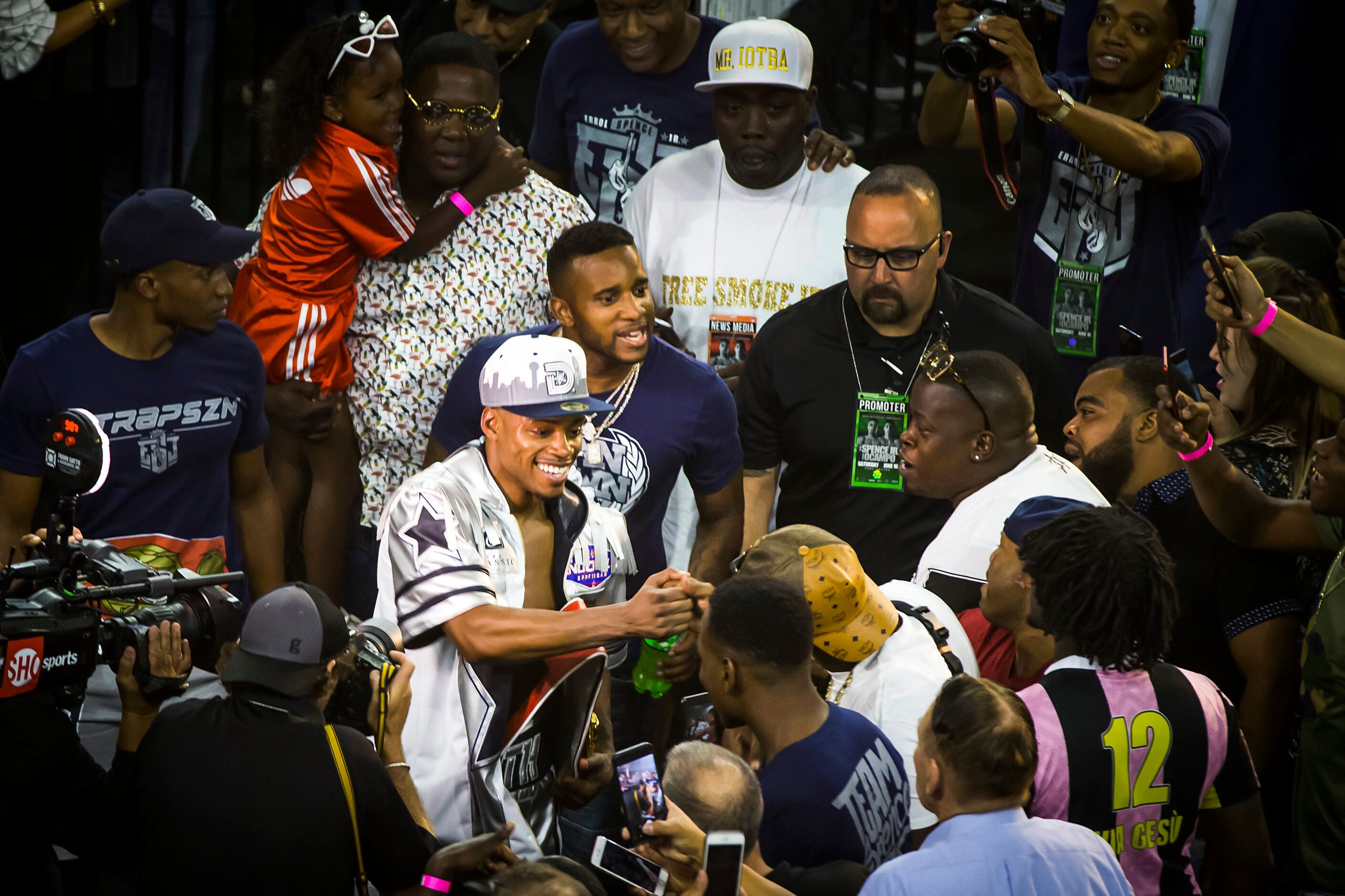 Welterweight champion Errol Spence Jr. celebrates with fans after he defended his IBF world...