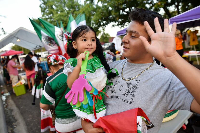 Michelle Ruano is held by her cousin Christian Soriano as they listen to music during the...